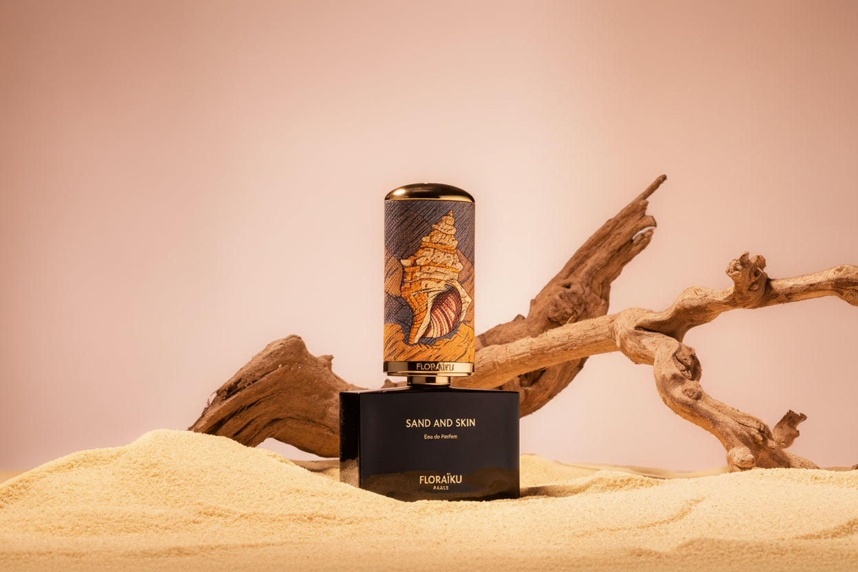 Perfume bottle with decorative label on sand and wood against a blue sky